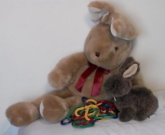 Big bunny slouched toward little bunny; unused chain on floor